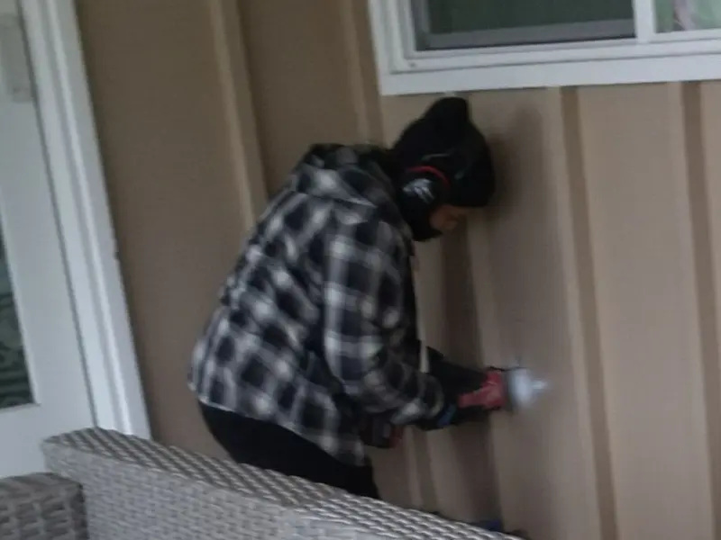 Professional electrician installing an exterior outlet in Scottsbluff